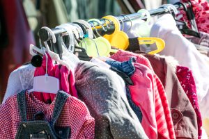 A rack of second-hand baby clothes