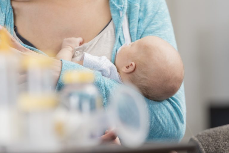 A new mom cradles her newborn baby