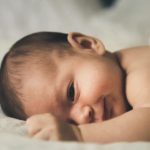 Baby laying on their belly headshot