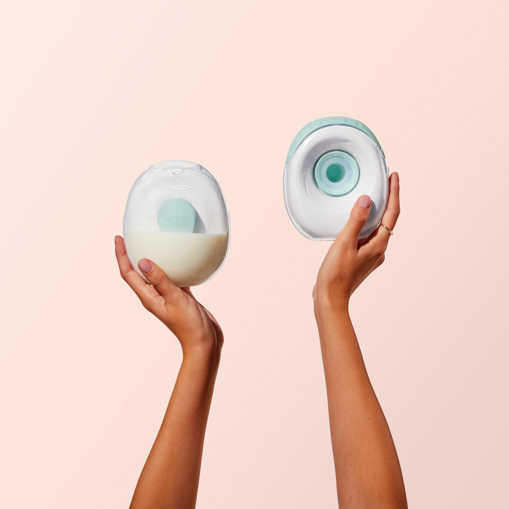Hands holding up a Willow Go breast pump