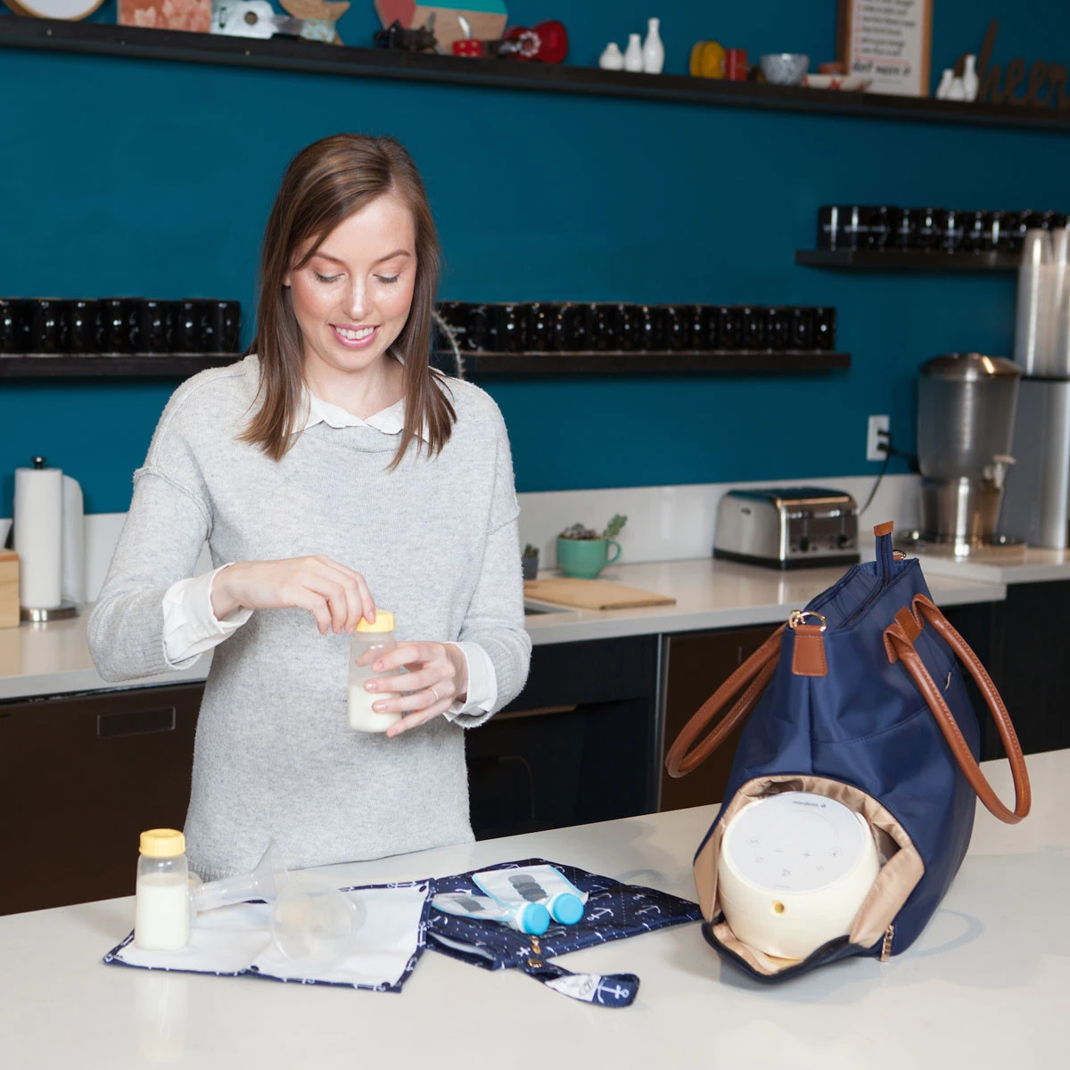 A woman uses her East Pump Bag