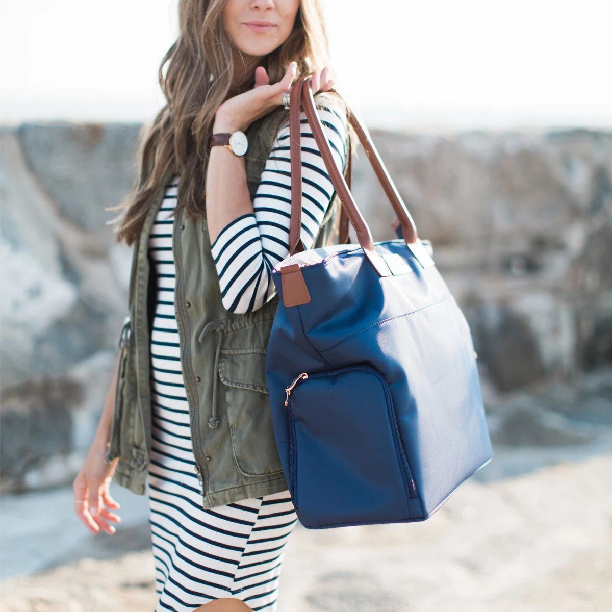 A woman uses her East Pump Bag