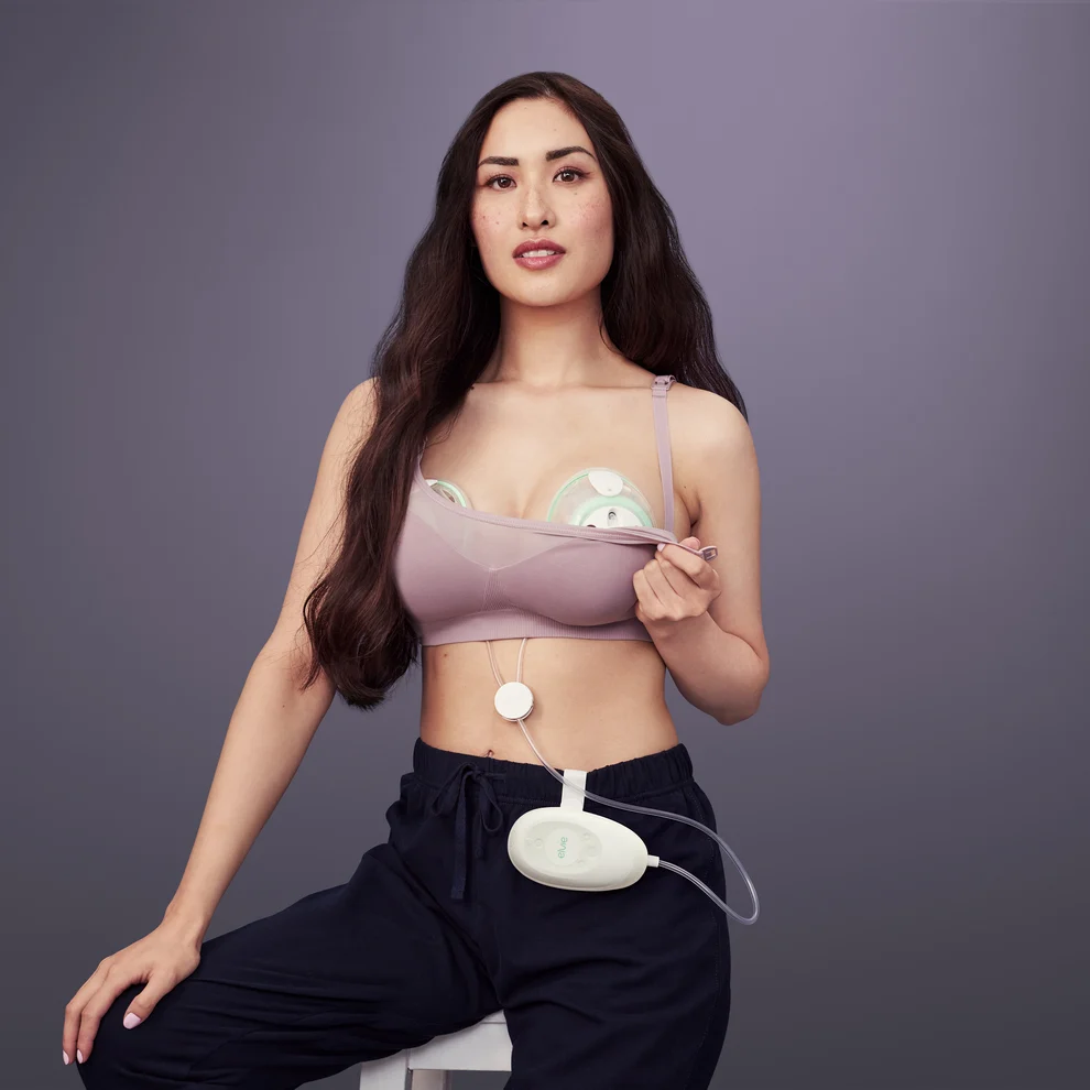 A woman uses an Elvie Stride breast pump under her clothing