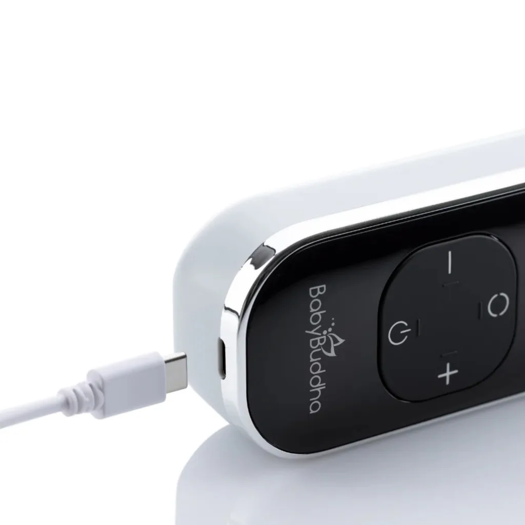 BabyBuddha 3.0 breast pump motor with its USB-C charging cable plugged in