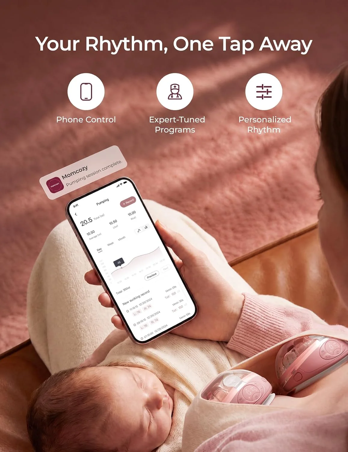 Mom holding her sleeping baby while pumping hands-free with the Momcozy W1 and the Momcozy app